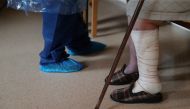 FILE PHOTO: A worker in a protective gear chats with a resident during lockdown amid the coronavirus disease (COVID-19) outbreak at Oteruelo nursing home in Valverde del Majano, Spain, April 21, 2020. REUTERS/Susana Vera/File Photo
