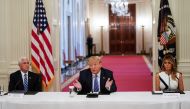 U.S. President Donald Trump is flanked by Vice President Mike Pence and first lady Melania Trump as he speaks during an event on reopening schools amid the coronavirus disease (COVID-19) pandemic in the East Room at the White House in Washington, U.S., Ju