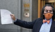 Attorney for Michael Cohen, Jeffrey Levine holds up a document as he tells the media Cohen has been remanded outside Federal Court in the Manhattan Borough of New York City, New York, U.S., July 9, 2020. REUTERS/Carlo Allegri
