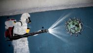 TOPSHOT - View of a mural depicting a man in protective suit spraying disinfectant on a coronavirus with Brazilian President Jair Bolsonaro's face, at the Tijuca neighborhood in RIO DE JANEIRO, Brazil on July 8, 2020, amid the new coronavirus pandemic. Br