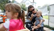 Barbara Andreas feeds her 11-month-old son Waylan during the reopen Florida 