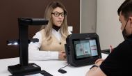 A female human-like robot assists a visitor at a multi-functional document processing centre in the city of Perm, Russia July 9, 2020. Promobot/Handout via REUTERS