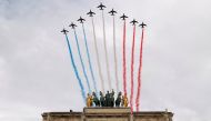 Alpha jets from the French Air Force Patrouille de France fly past the Arc de Triomphe du Carrousel, next to Le Louvre museum, during the Bastille Day celebrations in Paris, France, July 14, 2020. REUTERS/Christian Hartmann 
