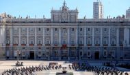 Attendees sit around a cauldron during a state ceremony to honour the 28,400 victims of the coronavirus crisis as well as those public servants who have been fighting on the front line against the pandemic in Spain, on July 16, 2020, at the Royal Palace i