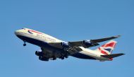 FILE PHOTO: A British Airways Boeing 747-400 flies into Heathrow Airport in west London May 12, 2011. British Airways cabin crew will meet on Thursday to consider an offer to end an 18-month dispute which has cost the airline more than 150 million pounds 