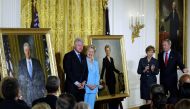 (FILES) In this file photo taken on June 14, 2004 Former US President Bill Clinton (L) and Senator Hillary Clinton (2nd-L) stand by their official White House portraits during the unveiling event hosted by President George W. Bush (R) and First Lady Laura
