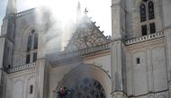 French firefighters battle a blaze at the Cathedral of Saint Pierre and Saint Paul in Nantes, France, July 18, 2020. REUTERS/Stephane Mahe
 