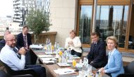 President of the European Council Charles Michel (L), Germany's Chancellor Angela Merkel (C), France's President Emmanuel Macron (2nd R) and President of the European Commission Ursula von der Leyen pose during a bilateral meeting at the EU summit on a co