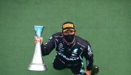 Mercedes' British driver Lewis Hamilton celebrates with the trophy after winning the Formula One Hungarian Grand Prix race at the Hungaroring circuit in Mogyorod near Budapest, Hungary, on July 19, 2020. / AFP / POOL / Mark Thompson