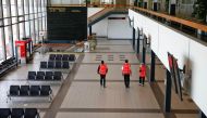 FILE PHOTO:Staff walks through an empty departure lounge at the Berlin Schoenefeld airport, amid the spread of the coronavirus disease (COVID-19) in Schoenefeld, Germany, May 26, 2020. REUTERS/Fabrizio Bensch
