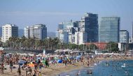 People swim and sunbathe at the Bogatell beach in BARCELONA, one of the several sands of the city that have been closed on July 19, 2020 due to reaching the allowed capacity. / AFP / Josep LAGO
