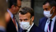 French President Emmanuel Macron, center, leaves the European Council building in the early morning during an EU summit in Brussels, on July 20, 2020. AFP / POOL / Olivier Matthys