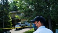 A man walks outside the home of federal judge Esther Salas, where her son was shot and killed and her defense attorney husband was critically injured, in North Brunswick, New Jersey, U.S. July 20, 2020. REUTERS/Eduardo Munoz

