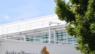 A sign is pictured outside the AstraZeneca factory in Liverpool north west England on July 20, 2020. Britain's government has already said it would purchase 100 million doses of a vaccine currently being trialed by Oxford University in partnership with As