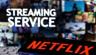 FILE PHOTO: A smartphone with the Netflix logo is seen on a keyboard in front of displayed 