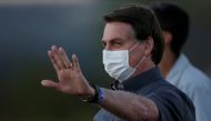 FILE PHOTO: Brazil's President Jair Bolsonaro gestures during a ceremony to lower the Brazilian National flag down for the night, at the Alvorada Palace, amid the coronavirus disease (COVID-19) outbreak, in Brasilia, Brazil, July 20, 2020. REUTERS/Ueslei 
