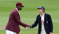Third Test - England v West Indies - Emirates Old Trafford, Manchester, Britain - July 24, 2020 England's Joe Root and West Indies' Jason Holder shake hands after the coin toss before the start of play, as play resumes behind closed doors following the ou