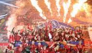 Liverpool's English midfielder Jordan Henderson (C) lifts the Premier League trophy during the presentation following the English Premier League football match between Liverpool and Chelsea at Anfield in Liverpool, north west England on July 22, 2020.  / 