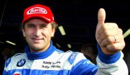 Alex Zanardi gives a thumbs up before the start of an LG Super Racing car event at the Monza race track October 19, 2003. REUTERS/Giampiero Sposito/File Photo
