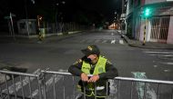 A colombian police officer guards an empty street during a curfew imposed in neighbourhoods due to high numbers of COVID-19 cases in Cali, Colombia on July 24, 2020. AFP / Luis ROBAYO