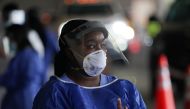 A medical worker in PPE looks on at a drive-thru COVID-19 testing site at the Mahaffey Theater on July 24, 2020 in St. Petersburg, Florida. Florida reported a record daily coronavirus death toll of 173 on July 23, 2020, in the latest reflection of the COV