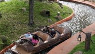 Social distancing seating measures are in place as people wearing facemasks ride Splash Mountain at Walt Disney World Resort's Magic Kingdom during the COVID-19 pandemic in Orlando on July 23, 2020. / AFP / Bryan R. Smith