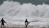 Surfers take to the waves at Pounder's Beach in Laie, Hawaii, U.S. July 26, 2020, as Hurricane Douglas makes its way towards Oahu. REUTERS/Marco Garcia
