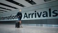A traveller wearing a face mask walks at the Terminal 5 at Heathrow Airport, as the spread of the?coronavirus?disease (COVID-19) continues, in London, Britain, July 26, 2020. REUTERS/Henry Nicholls

