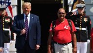 US President Donald Trump greets Marine veteran Terry Sharpe(C), who walked from North Carolina to Washington to raise awareness about veterans' suicides, at the White House in Washington, DC, on July 27, 2020. Terry often refers to his walk as “300 Miles