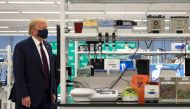 US President Donald Trump wears a mask, alongside Fujifilm Diosynth Biotechnologies CEO Martin Messon (R), as they tour a lab where they are making components for a potential vaccine at the Bioprocess Innovation Center at Fujifilm Diosynth Biotechnologies