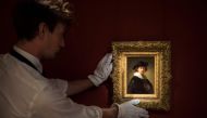 A handout picture released by Sothebys on July 28, 2020 shows an assistant holding a self-portrait by Dutch artist Rembrandt in London. One of the last self-portraits by Rembrandt still in private hands goes on sale in Britain today, with a guide price of