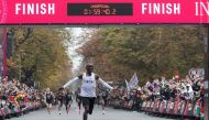 In this file photo taken on October 12, 2019, Kenya's Eliud Kipchoge, wearing the Nike AlphaFly prototype shoes, celebrates as he crosses the finish line at the end of his attempt to bust the mythical two-hour barrier for the marathon in Vienna. World Ath