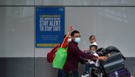 Travellers wearing face masks walk at the Terminal 5 at Heathrow Airport, as the spread of the coronavirus disease (COVID-19) continues, in London, Britain, July 26, 2020. REUTERS/Henry Nicholls