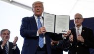 U.S. President Donald Trump is applauded as he displays a presidential permit for energy development that he signed during a tour of the Double Eagle Energy Oil Rig in Midland, Texas, U.S., July 29, 2020. REUTERS/Carlos Barria