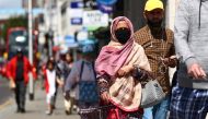 People walk down a street following the coronavirus disease (COVID-19) outbreak, in Ilford, London, Britain July 29, 2020. REUTERS/Hannah McKay