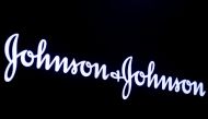 FILE PHOTO: The company logo for Johnson & Johnson is displayed on a screen to celebrate the 75th anniversary of the company's listing at the New York Stock Exchange (NYSE) in New York, U.S., September 17, 2019. REUTERS/Brendan McDermid/File Photo
