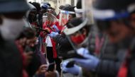 Workers from an AFP (Pension Fund Administrators) branch office, wearing face shields, help their customers to update their personal information to withdraw 10% of their pension savings, to help ease the economic pain wrought by the coronavirus disease (C