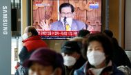 FILE PHOTO: People watch a TV broadcasting a news report on a news conference held by Lee Man-hee, founder of the Shincheonji Church of Jesus the Temple of the Tabernacle of the Testimony, in Seoul, South Korea, March 2, 2020. REUTERS/Heo Ran/File Photo