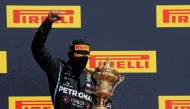 Winner Mercedes' British driver Lewis Hamilton celebrates with his trophy on the podium after the Formula One British Grand Prix at the Silverstone motor racing circuit in Silverstone, central England on August 2, 2020. (AFP / POOL / Frank Augstein)
 