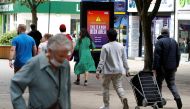People walk along a street in the Sale area of Manchester, as the city and the surrounding area faces local restrictions in an effort to avoid a local lockdown being forced upon the area, amid the coronavirus disease (COVID-19) outbreak, Britain, August 1