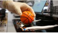 Dr. Benjamin Tee, Assistant Professor of Materials Science and Engineering at the National University of Singapore (NUS), demonstrates how his device can detect the texture of a soft stress ball at a lab in NUS, Singapore July 27, 2020. Picture taken July