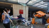 A woman sweeps at a damaged hospital following Tuesday's blast, in Beirut Lebanon August 5, 2020. REUTERS/Mohamed Azakir