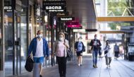 People wearing a face mask walks on the Lijnbaan, in Rotterdam on August 5, 2020, as from today, wearing a face mask is mandatory in five usually crowded places in the city.  AFP / Pieter STAM DE JONGE
