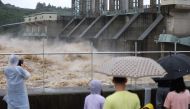 People watch as water from the Imjin river is discharged through the Gunnam Dam in Yeoncheon following heavy rain fall on August 6, 2020.  / AFP / YONHAP /