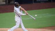 Aug 5, 2020; San Diego, California, USA; San Diego Padres right fielder Wil Myers (4) hits a home run during the eighth inning against the Los Angeles Dodgers at Petco Park. Mandatory Credit: Orlando Ramirez-USA TODAY Sports