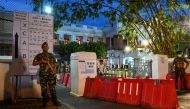 A Special Task Force (STF) soldier (L) stands guard at the main counting centre in Colombo on August 6, 2020, a day after Sri Lanka's parliamentary election. / AFP / LAKRUWAN WANNIARACHCHI
