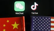 The messenger app WeChat and short-video app TikTok are seen near China and U.S. flags in this illustration picture taken August 7, 2020. REUTERS/Florence Lo/Illustration
