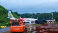 A man walks near the wreckage of an Air India Express jet at Calicut International Airport in Karipur, Kerala, on August 8, 2020.  AFP / Arunchandra BOSE