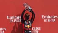 Formula One F1 - 70th Anniversary Grand Prix - Silverstone Circuit, Silverstone, Britain - August 9, 2020 Red Bull's Max Verstappen celebrates his win on the podium after the race Pool via REUTERS/Frank Augstein