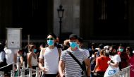People wearing protective masks walk near the Louvre Museum as France reinforces mask-wearing as part of efforts to curb a resurgence of the coronavirus disease (COVID-19) across the country, in Paris, France August 6, 2020. REUTERS/Gonzalo Fuentes/File P